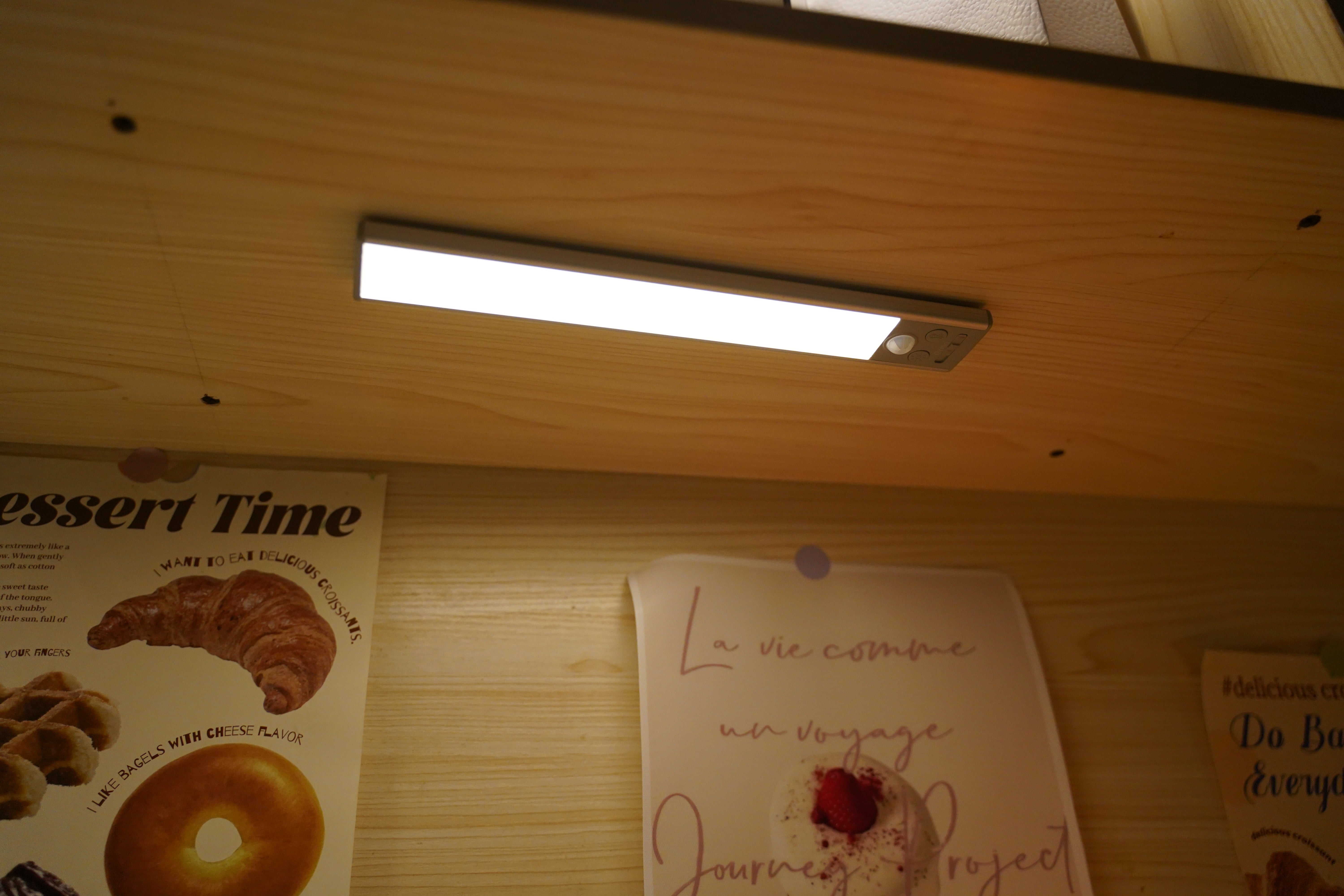 Gritin 84 LED Rechargeable Motion Sensor Under Cabinet Light mounted under a wooden shelf casting bright downward light