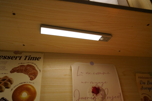 Gritin 84 LED Rechargeable Motion Sensor Under Cabinet Light mounted under a wooden shelf casting bright downward light