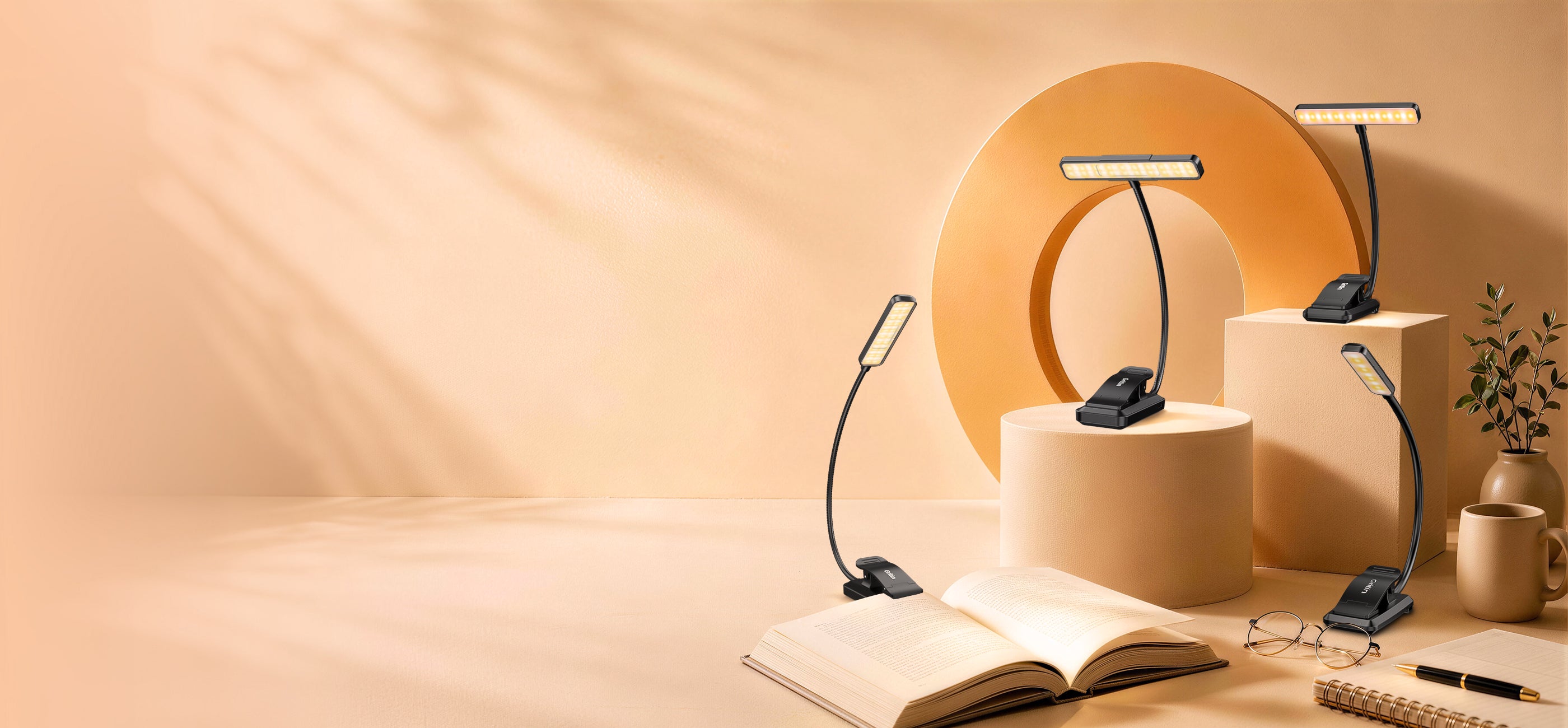 Four Gritin rechargeable clip-on book lights displayed beside an open book in a warm reading setting